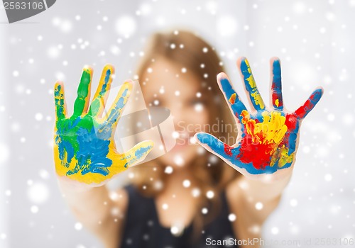 Image of girl showing painted hands