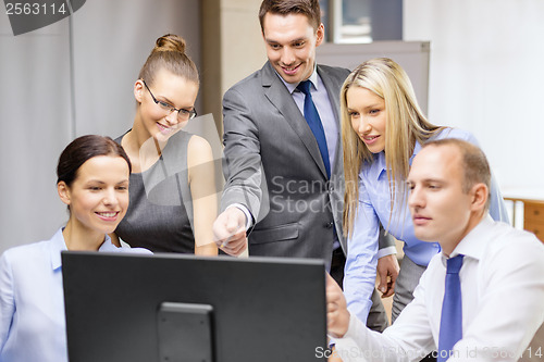 Image of business team with monitor having discussion