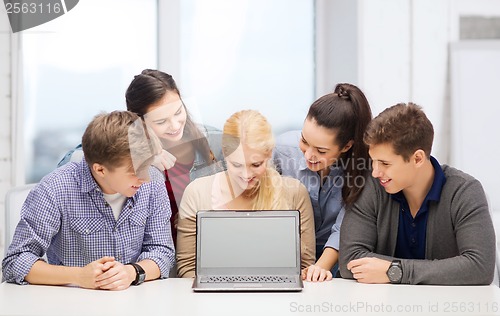 Image of smiling students looking at blank lapotop screen