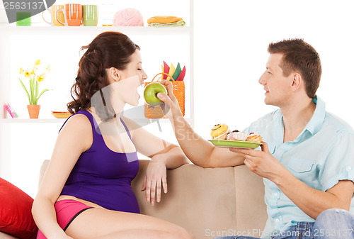 Image of happy expecting parents at home