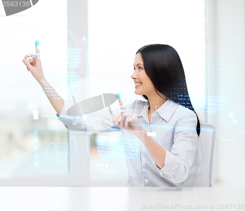 Image of smiling woman pointing to virtual screen