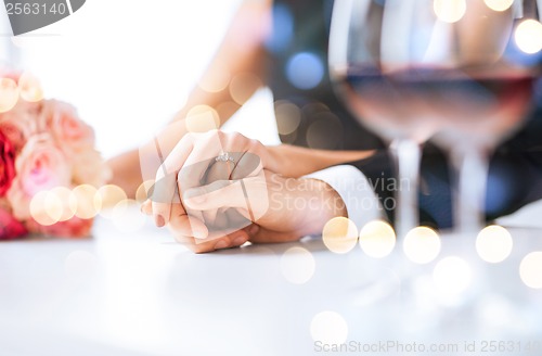 Image of engaged couple with wine glasses