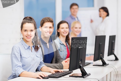 Image of students with computer monitor at school