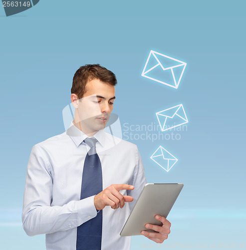 Image of buisnessman with tablet pc and envelope