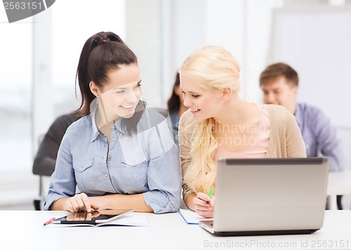 Image of students with laptop, tablet pc and notebooks