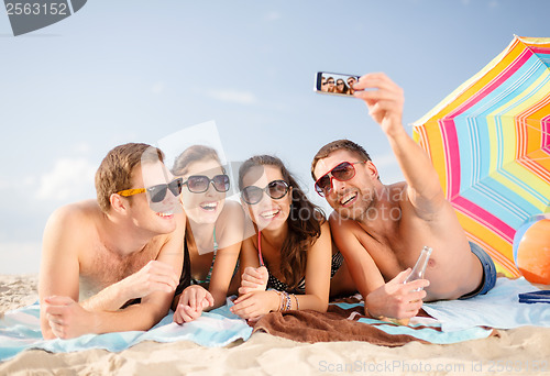 Image of group of people taking picture with smartphone