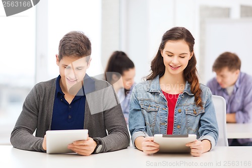 Image of students looking at tablet pc in lecture at school