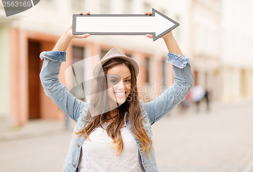 Image of girl showing direction with arrow in the city