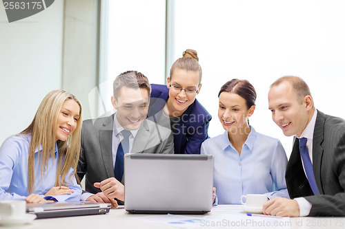 Image of business team with laptop having discussion