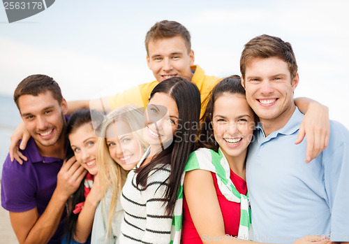 Image of group of friends having fun on the beach