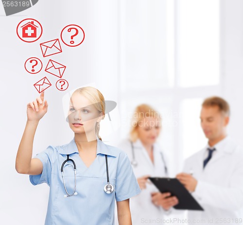 Image of focused doctor or nurse pointing to red envelope