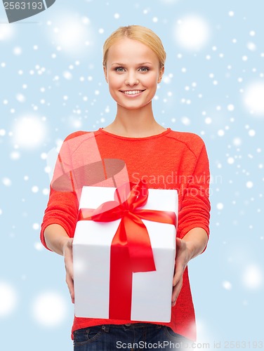 Image of smiling woman in red sweater with gift box