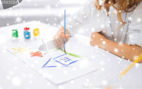Image of little girl painting picture