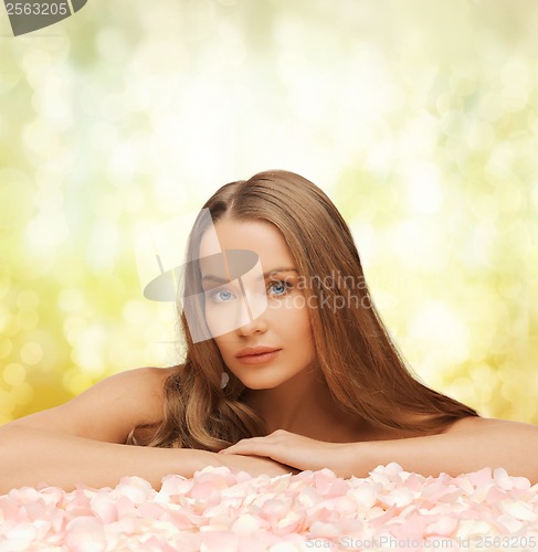 Image of woman with long hair and rose petals
