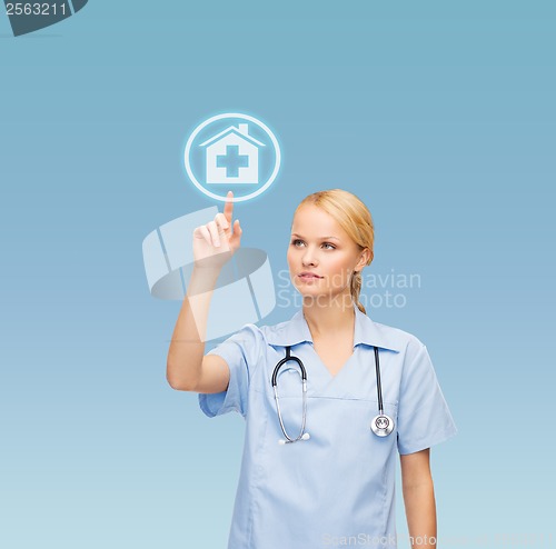 Image of smiling doctor or nurse pointing to hospital icon