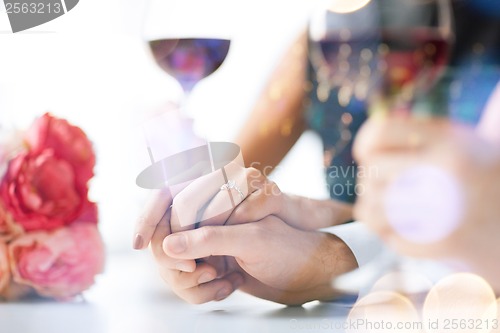 Image of engaged couple with wine glasses