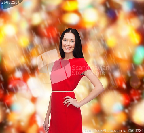 Image of smiling young woman in red dress