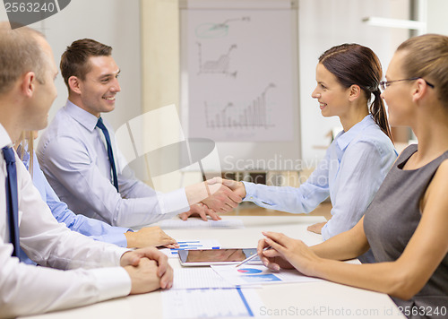 Image of businessman and businesswoman shaking hands