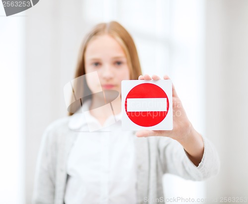 Image of girl showing no entry sign