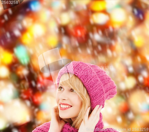 Image of woman in pink hat and scarf