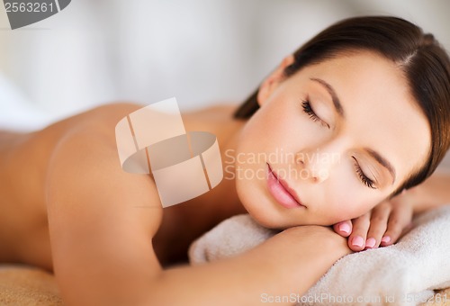 Image of beautiful woman with closed eyes in spa