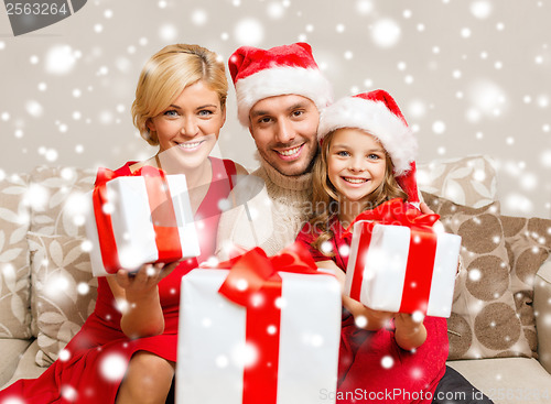 Image of smiling family giving many gift boxes