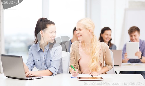 Image of students with laptop, tablet pc and notebooks