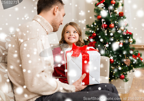 Image of smiling father and daughter looking at each other