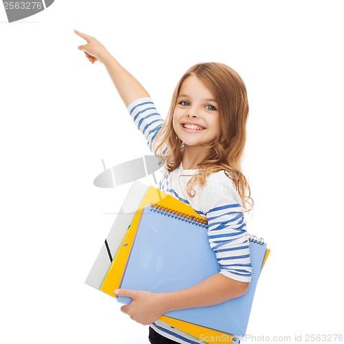 Image of cute girl with folders pointing at virtual screen