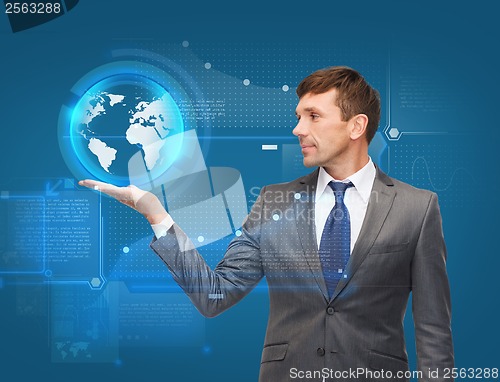 Image of buisnessman holding virtual sphere globe