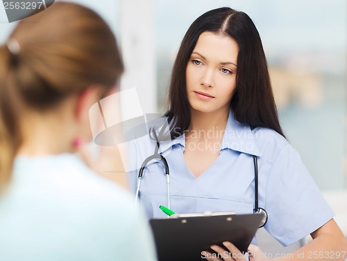 Image of female doctor or nurse with patient