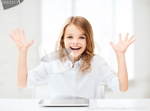 Image of laughing girl with tablet pc computer and hands up