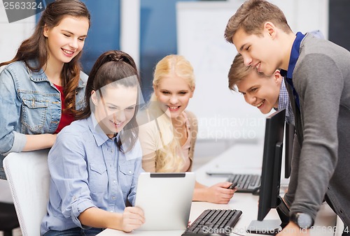 Image of students with computer monitor and tablet pc