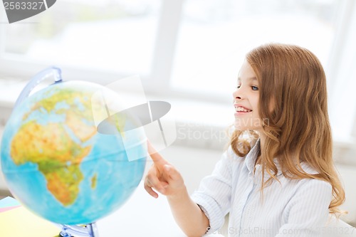 Image of smiling student girl with globe at school