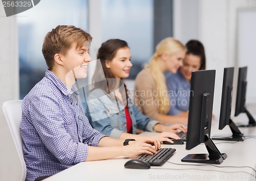 Image of students looking at computer monitor at school