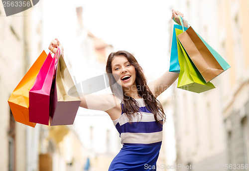 Image of beautiful woman with shopping bags in the ctiy