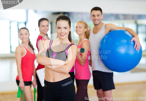 Image of woman standing in front of the group in gym