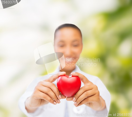 Image of woman hands with red heart