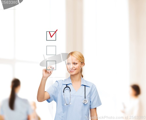 Image of doctor or nurse drawing checkmark into checkbox