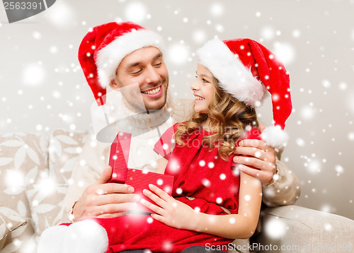 Image of smiling father and daughter opening gift box