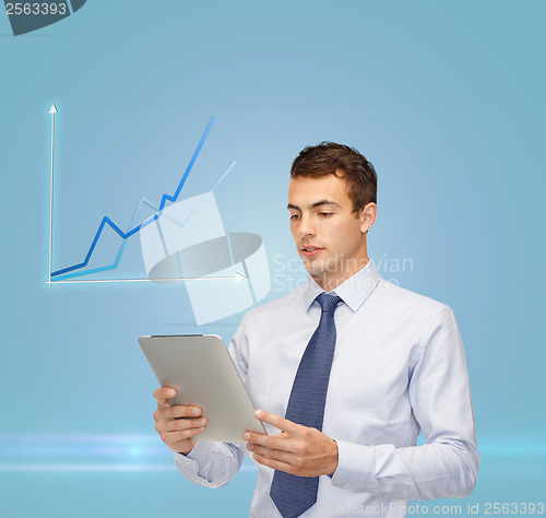 Image of buisnessman with tablet pc and graph