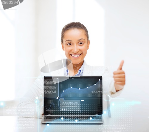 Image of smiling woman with laptop computer