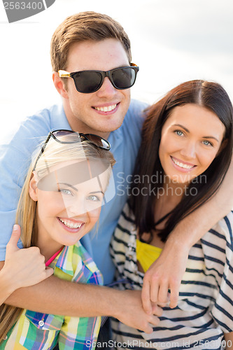 Image of group of friends having fun on the beach