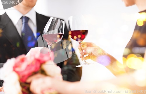 Image of engaged couple with wine glasses