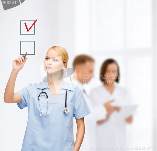 Image of doctor or nurse drawning checkmark into checkbox