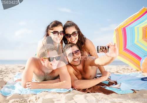 Image of group of people taking picture with smartphone