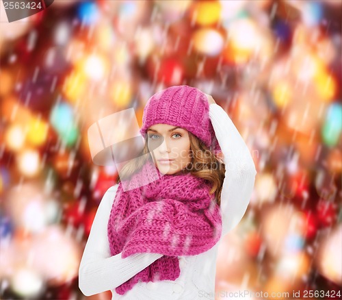 Image of woman in pink hat and scarf