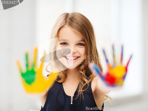 Image of smiling girl showing painted hands