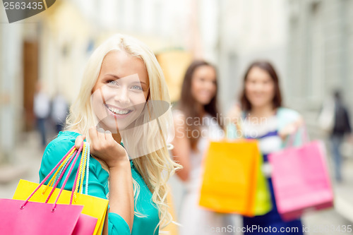 Image of beautiful woman with shopping bags in the ctiy