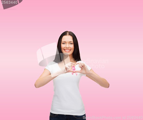 Image of smiling woman with pink cancer awareness ribbon